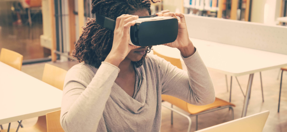 African American library user using VR headset for work