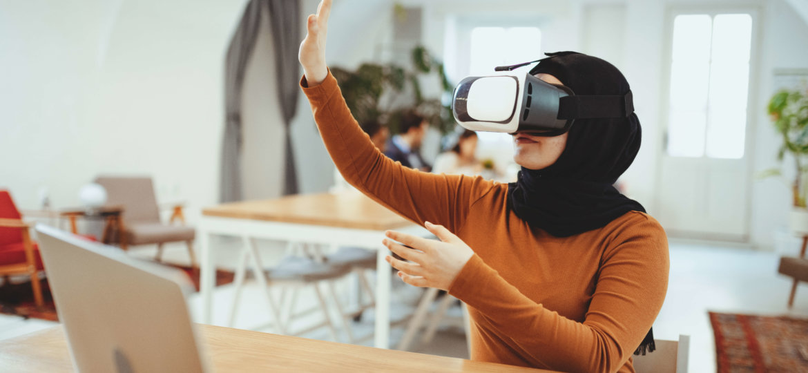 Young Middle Eastern businesswoman with virtual reality glasses in the office